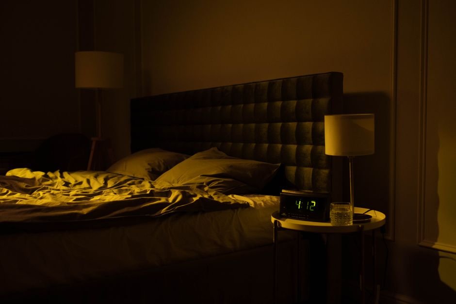 Alarm clock in a dark bedroom at 3 AM — the hour of the on-call DBA phone call