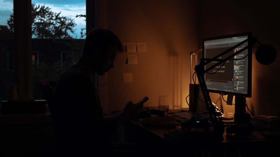 Dark office at night lit only by a computer screen — the hour when mission-critical databases fail