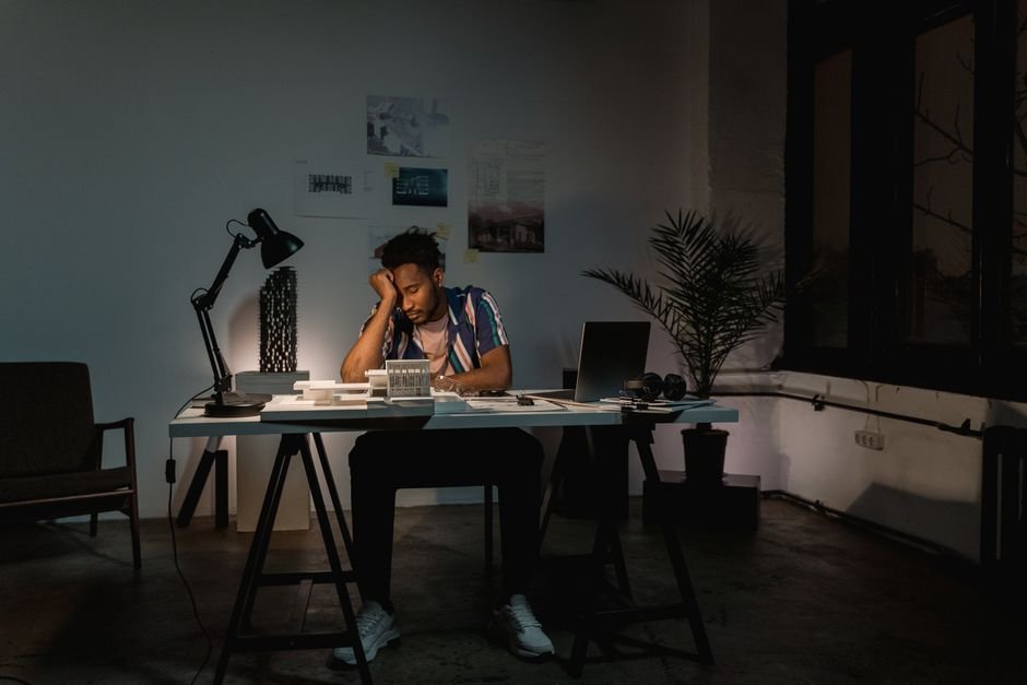 Engineer working on a laptop late at night handling a database incident