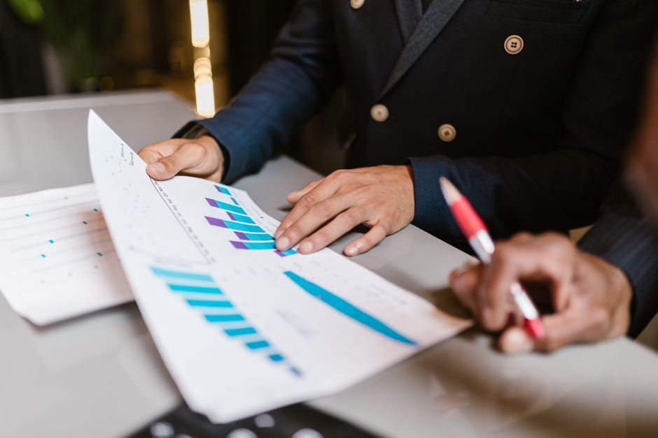 Business team reviewing AI-powered reporting dashboard charts in a meeting
