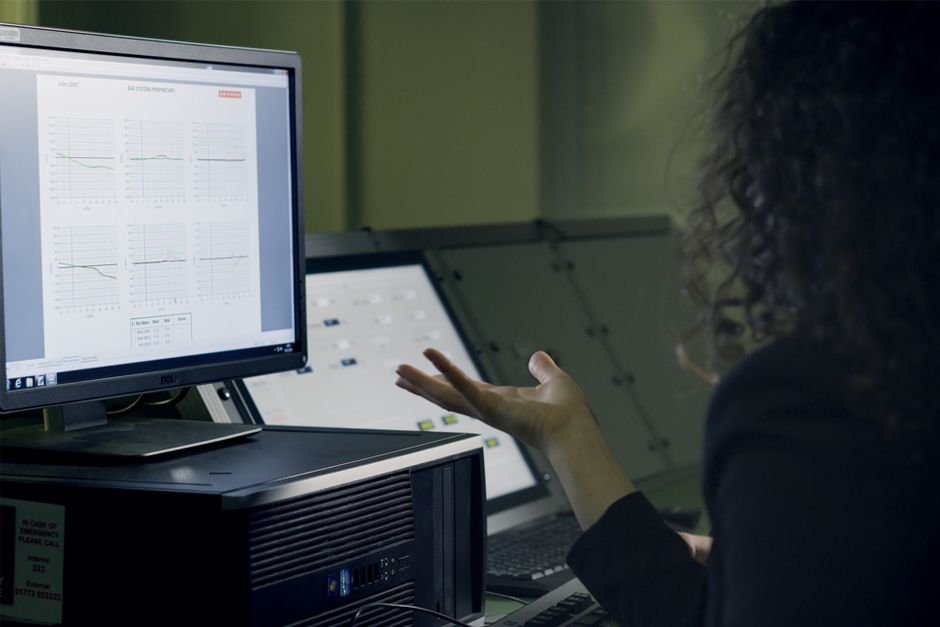 Engineer analyzing performance data on a monitor, the daily work of reading Oracle AWR reports