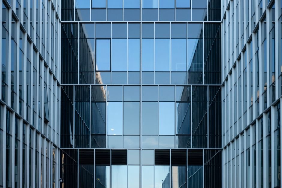 Modern glass office building — consolidating legacy Oracle databases into one multitenant container database