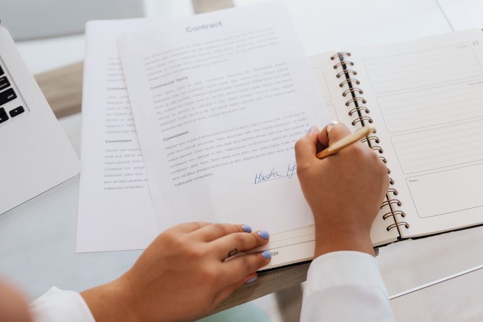 Hands signing legal documents, the audit and evidence discipline compliant AI data governance requires